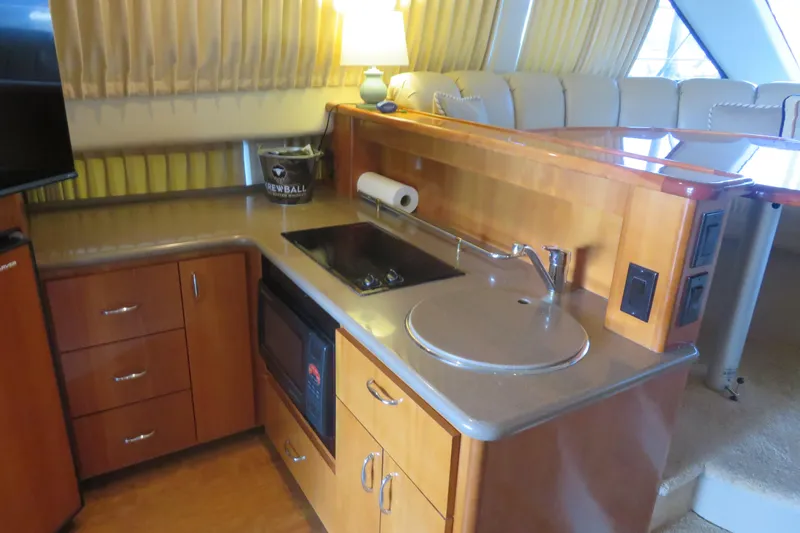 Slide: The Image of 2006 Carver 38 Super Sport yacht interior kitchen with stove, sink, and microwave. - 8
