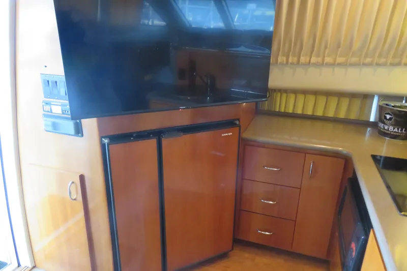 Slide: The Image of Interior of 2006 Carver 38 Super Sport yacht with kitchenette and TV. - 9