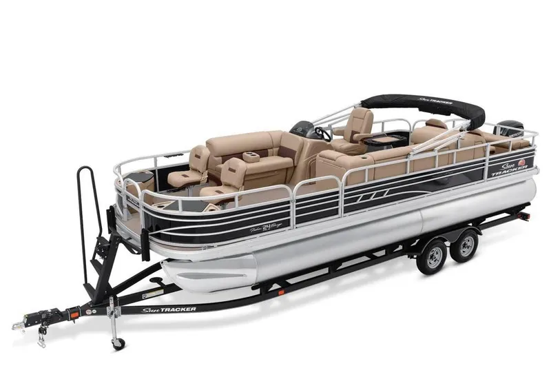 The Image of 2021 Sun Tracker Fishin' Barge 24 DLX pontoon boat on trailer, featuring spacious seating. - 0