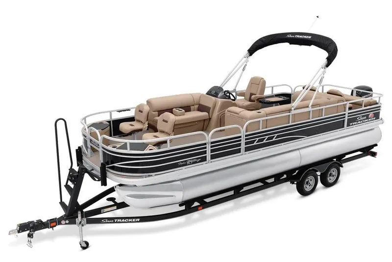 Slide: The Image of 2021 Sun Tracker Fishin' Barge 24 DLX pontoon boat on trailer, featuring spacious seating. - 5