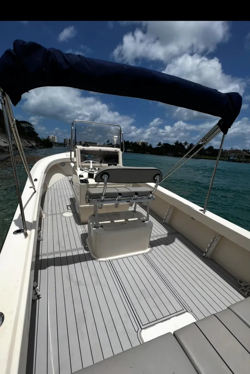 Slide: The Image of 2002 Parker 2500 Special Edition boat with canopy on calm water. - 10