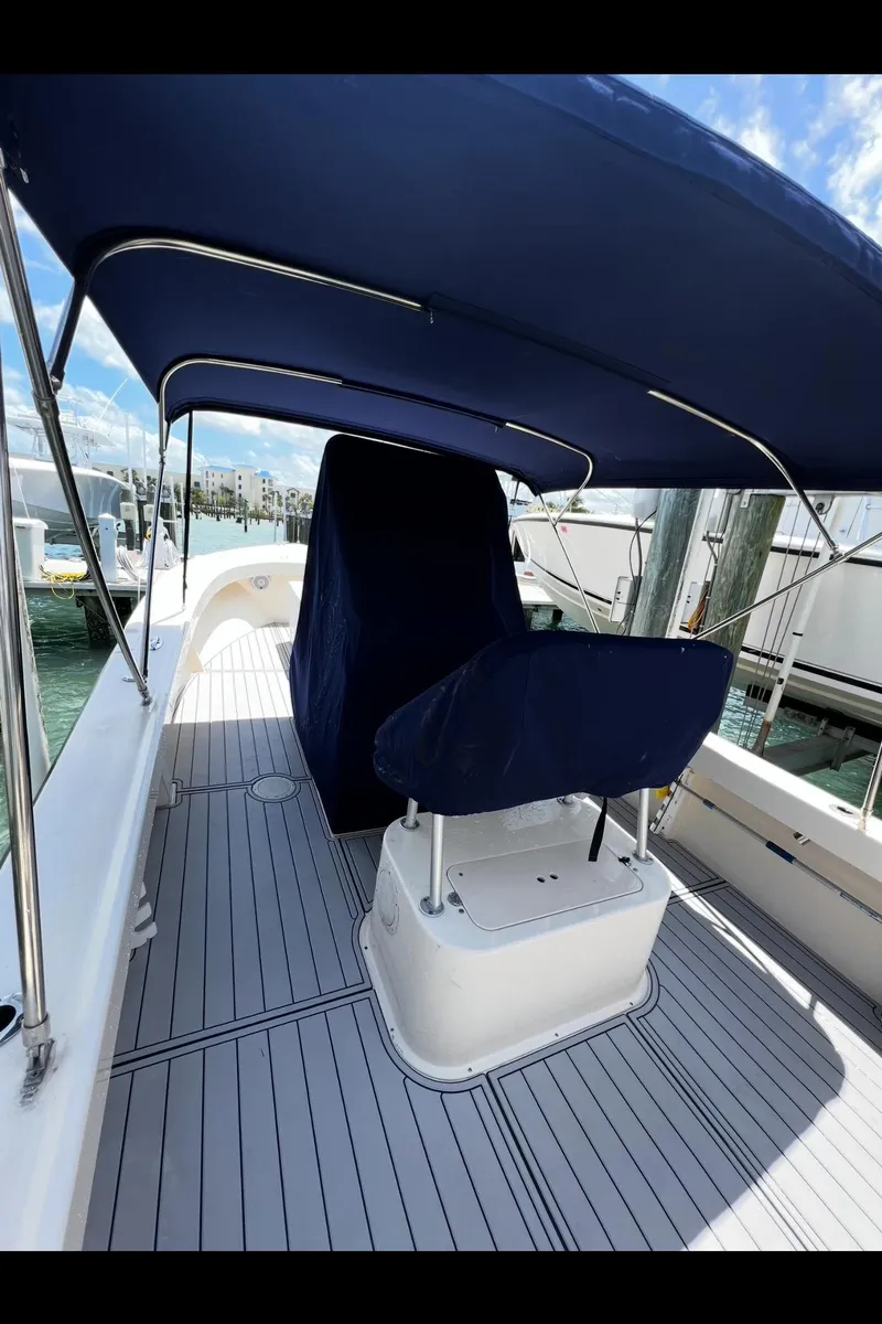 Slide: The Image of 2002 Parker 2500 Special Edition boat with blue canopy and covered seating. - 12