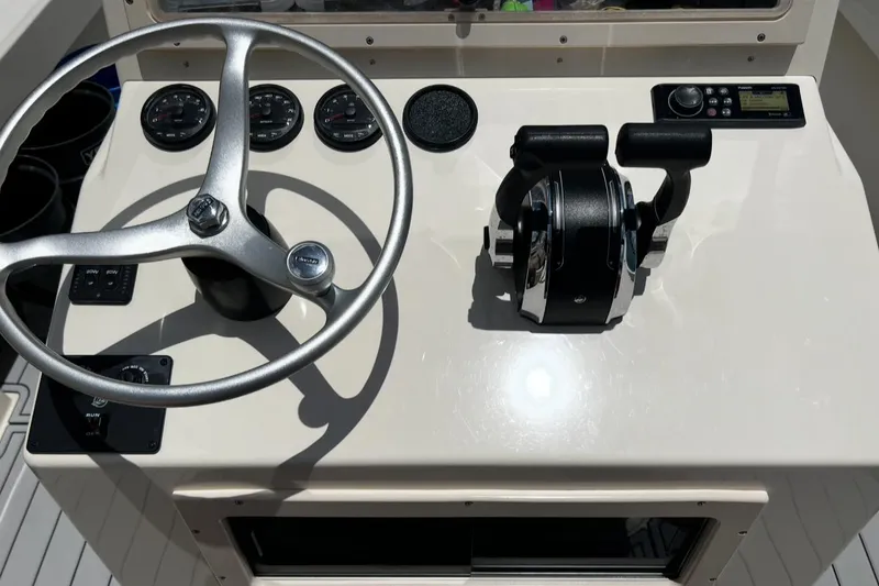 Slide: The Image of Steering console of a 2002 Parker 2500 Special Edition boat with gauges and controls. - 13