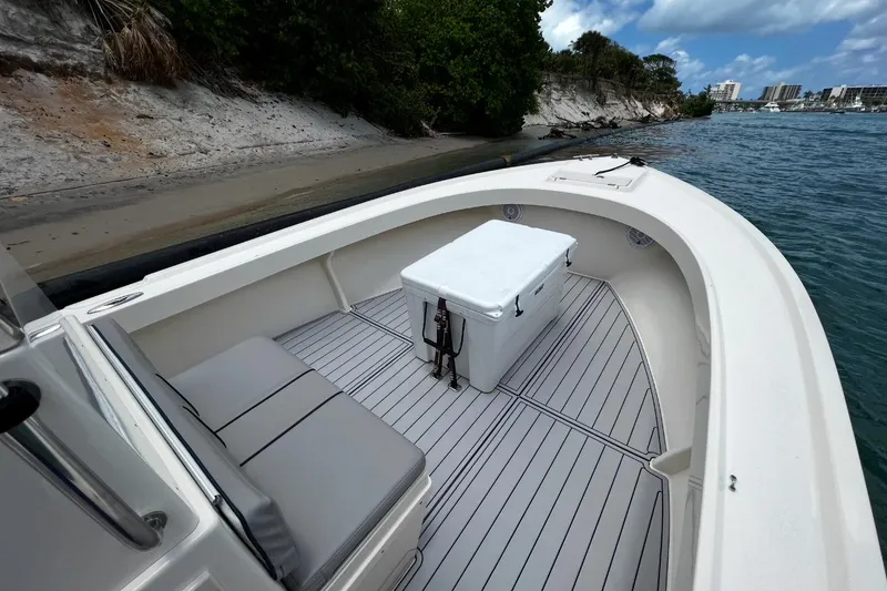 Slide: The Image of Parker 2500 Special Edition boat, 2002 model, docked by sandy shore with cooler on deck. - 15