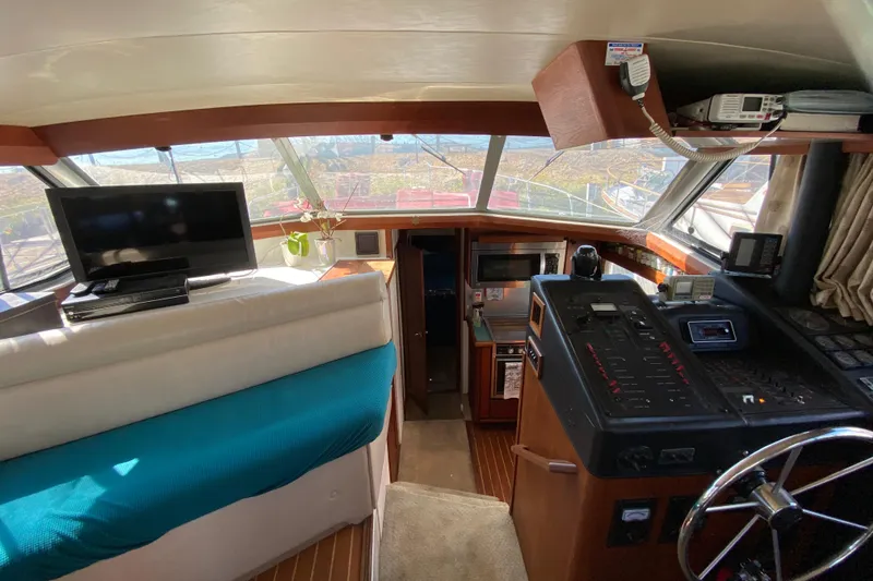 Slide: The Image of Interior of 1989 Bayliner 3888 Motoryacht with helm, electronics, and seating area. - 13