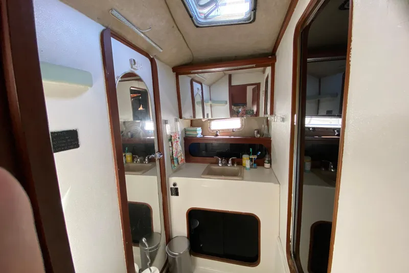 Slide: The Image of 1989 Bayliner 3888 Motoryacht bathroom with sink, mirror, and storage cabinets. - 20