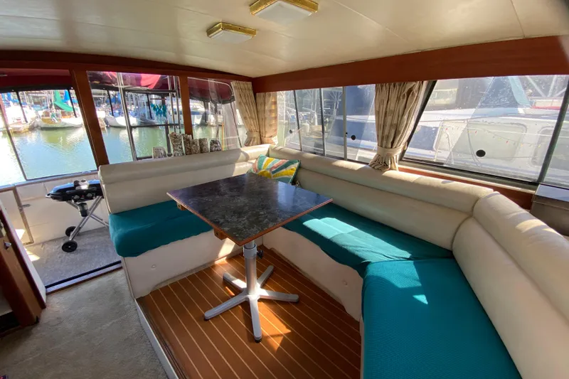 Slide: The Image of 1989 Bayliner 3888 Motoryacht interior with cozy seating and waterfront view. - 26