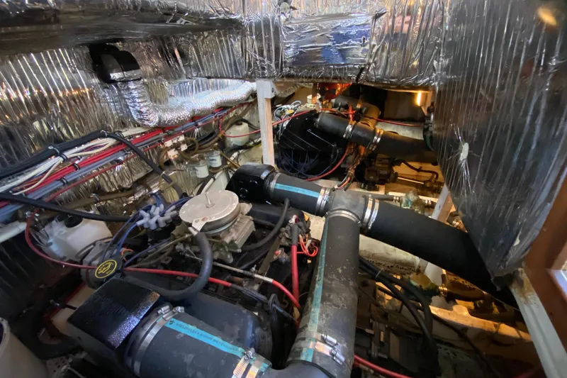 Slide: The Image of Engine room of 1989 Bayliner 3888 Motoryacht with visible wiring and components. - 32