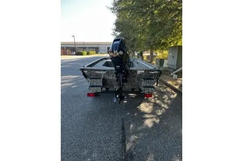 Slide: The Image of 2026 Tracker Grizzly 1654 T Sportsman boat on trailer, parked outdoors. - 3