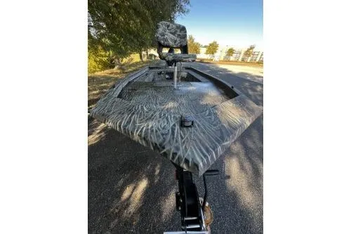 Slide: The Image of 2026 Tracker Grizzly 1654 T Sportsman boat with camouflage design on a sunny day. - 5