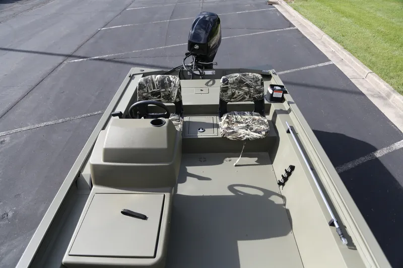 Slide: The Image of 2026 Tracker Grizzly 1754 SC boat with camouflage seats and steering console. - 3