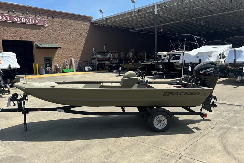 The Image of 2026 Tracker Grizzly 1648 SC boat on trailer at service center. - 0
