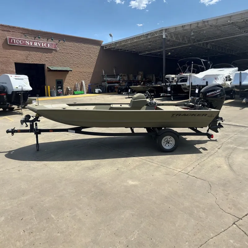 The Image of 2026 Tracker Grizzly 1648 SC boat on trailer at service center. - 0