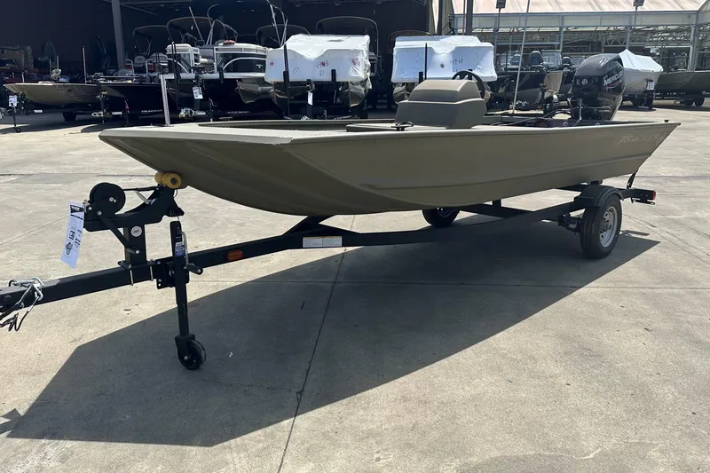 Slide: The Image of 2026 Tracker Grizzly 1648 SC boat on trailer in outdoor showroom. - 2