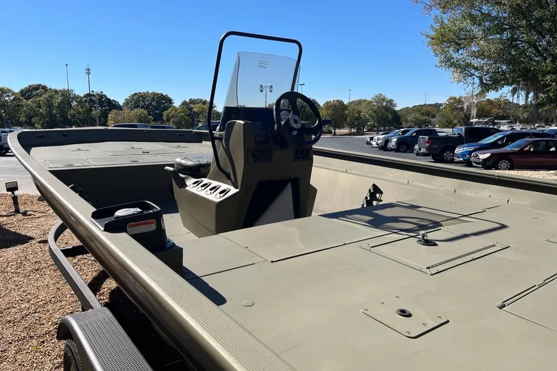 Slide: The Image of 2025 Tracker Grizzly 2072 CC boat with console, parked outdoors under clear sky. - 4