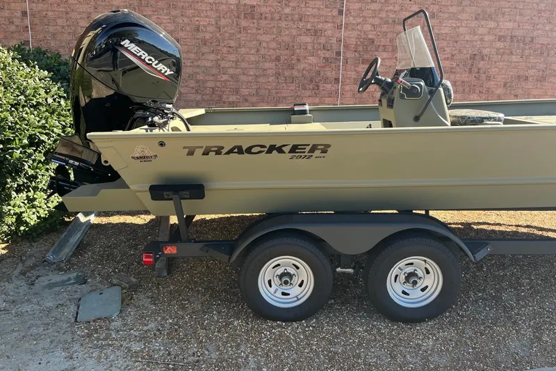 Slide: The Image of 2025 Tracker Grizzly 2072 CC boat on trailer with Mercury outboard motor. - 5
