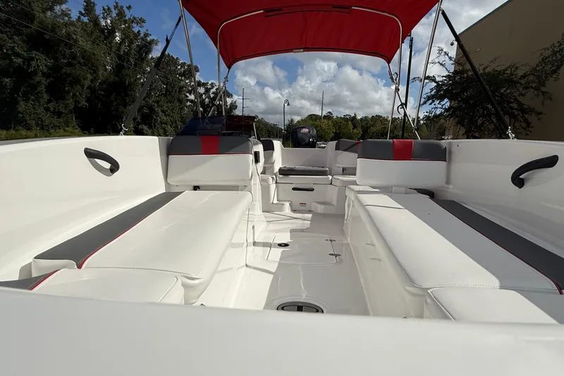 Slide: The Image of 2026 Tahoe T18 boat interior with red canopy, white seating, and modern design. - 3