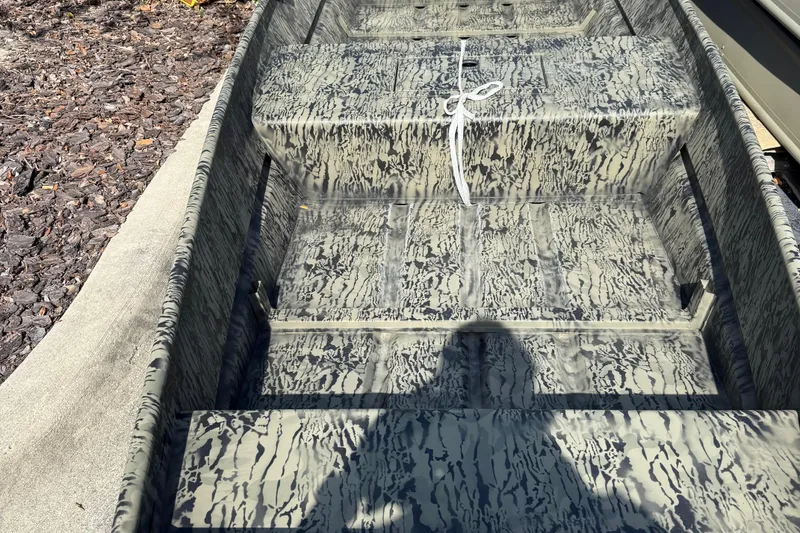 Slide: The Image of 2026 Tracker Grizzly 15 Jon boat with camouflage interior design. - 2