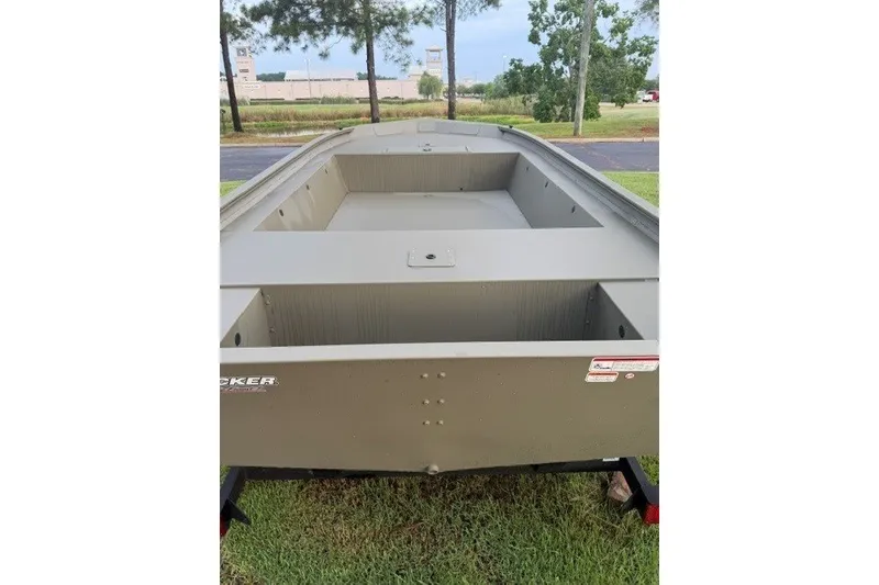Slide: The Image of 2026 Tracker Grizzly 1754 Utility boat on grass, showcasing spacious interior design. - 4
