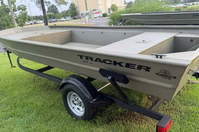Slide: The Image of 2026 Tracker Grizzly 1754 Utility boat on trailer, parked on grass. - 3