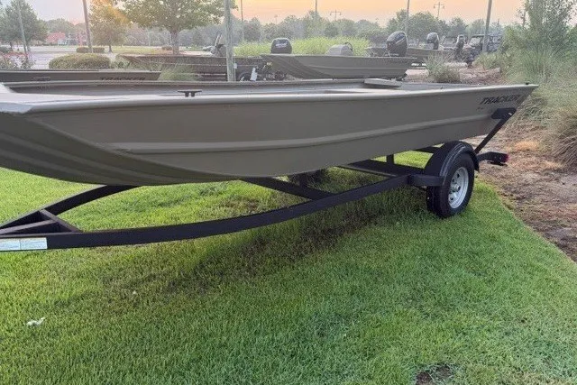 The Image of 2026 Tracker Grizzly 1754 Utility boat on trailer, parked on grass. - 0