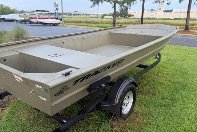 Slide: The Image of 2026 Tracker Grizzly 1754 Utility boat on trailer, parked on grass. - 2