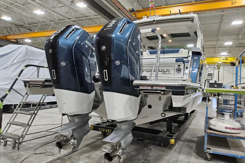 Slide: The Image of 2026 Formula 380 Super Sport Crossover OB with dual Mercury outboard engines in a workshop. - 1