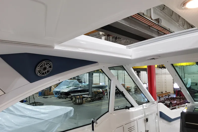 Slide: The Image of Interior view of 2026 Formula 380 Super Sport Crossover OB boat in a workshop. - 104