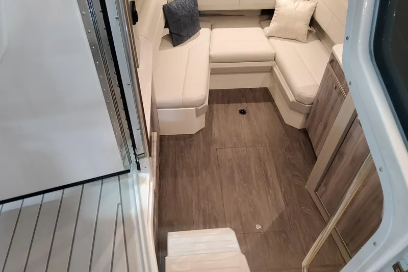 Slide: The Image of 2026 Formula 380 Super Sport Crossover OB cabin with modern seating and wood flooring. - 109