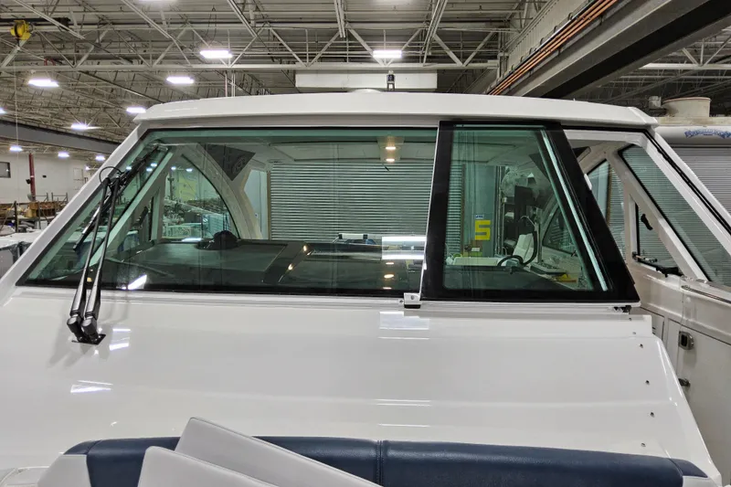 Slide: The Image of 2026 Formula 380 Super Sport Crossover OB boat windshield in a factory setting. - 11