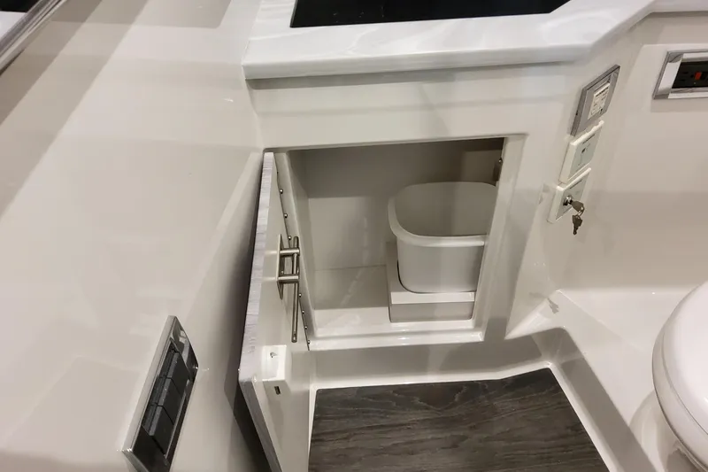 Slide: The Image of 2026 Formula 380 Super Sport Crossover OB interior with open cabinet and waste bin. - 131