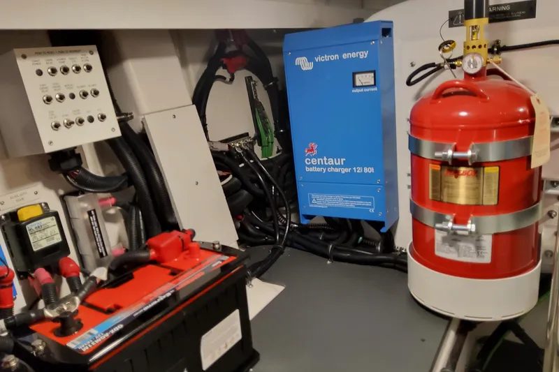 Slide: The Image of Engine room of 2026 Formula 380 Super Sport Crossover OB with battery charger and fire extinguisher. - 146