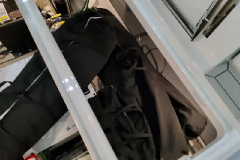 Slide: The Image of Storage compartment of 2026 Formula 380 Super Sport Crossover OB boat, featuring black bags. - 151