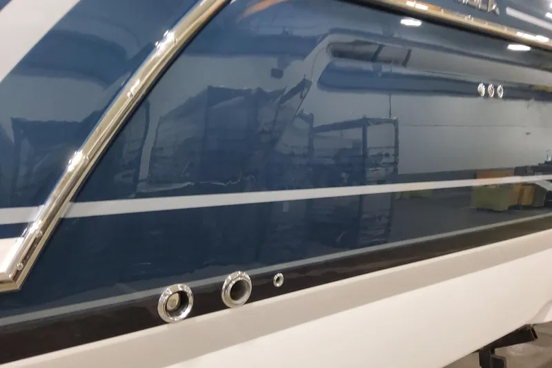 Slide: The Image of 2026 Formula 380 Super Sport Crossover OB boat exterior with sleek blue and white design. - 23