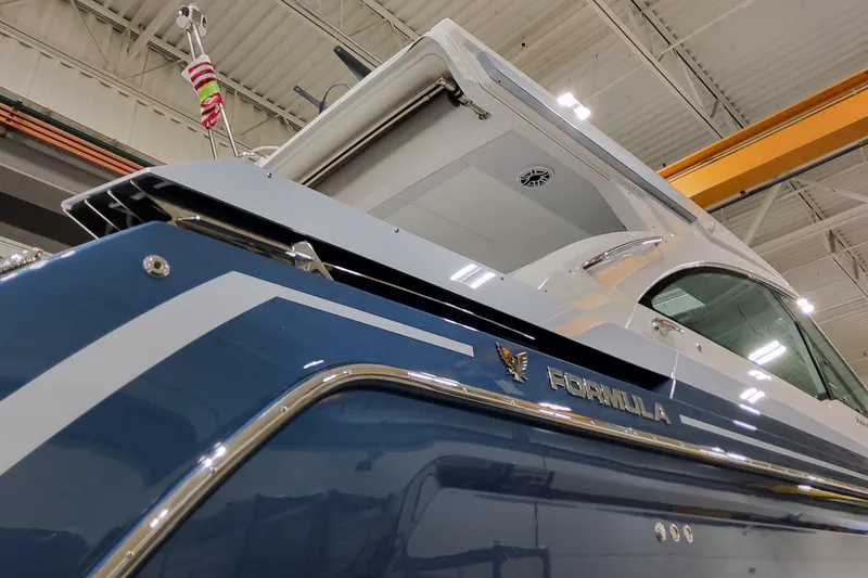 Slide: The Image of 2026 Formula 380 Super Sport Crossover OB boat in a showroom, showcasing sleek design. - 24