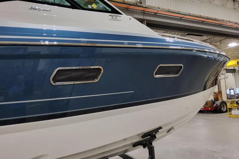 Slide: The Image of 2026 Formula 380 Super Sport Crossover OB boat in a showroom setting. - 26