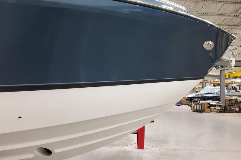 Slide: The Image of 2026 Formula 380 Super Sport Crossover OB boat in a showroom, showcasing sleek hull design. - 28
