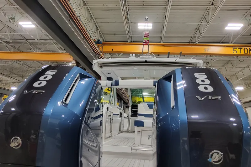 Slide: The Image of 2026 Formula 380 Super Sport Crossover OB with dual 600 V12 engines in a warehouse. - 30