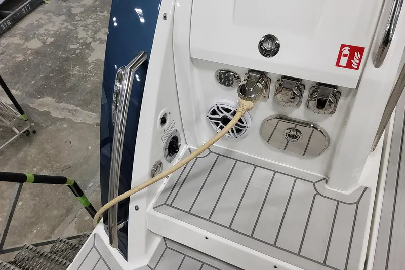 Slide: The Image of 2026 Formula 380 Super Sport Crossover OB boat deck with utility connections and speaker. - 41