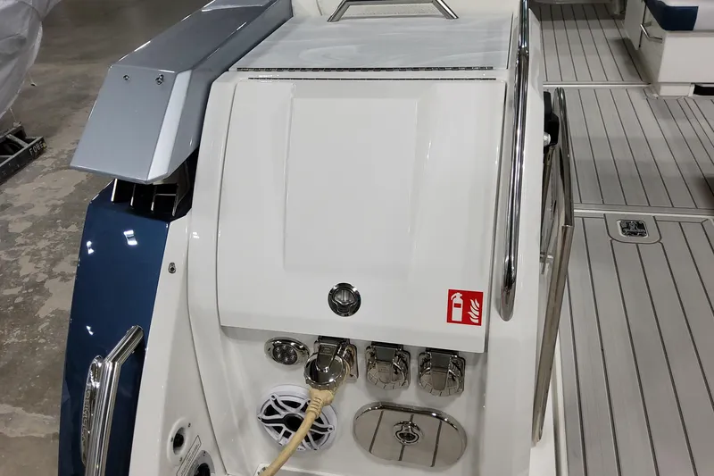 Slide: The Image of 2026 Formula 380 Super Sport Crossover OB boat deck with modern fittings and fire safety sign. - 42