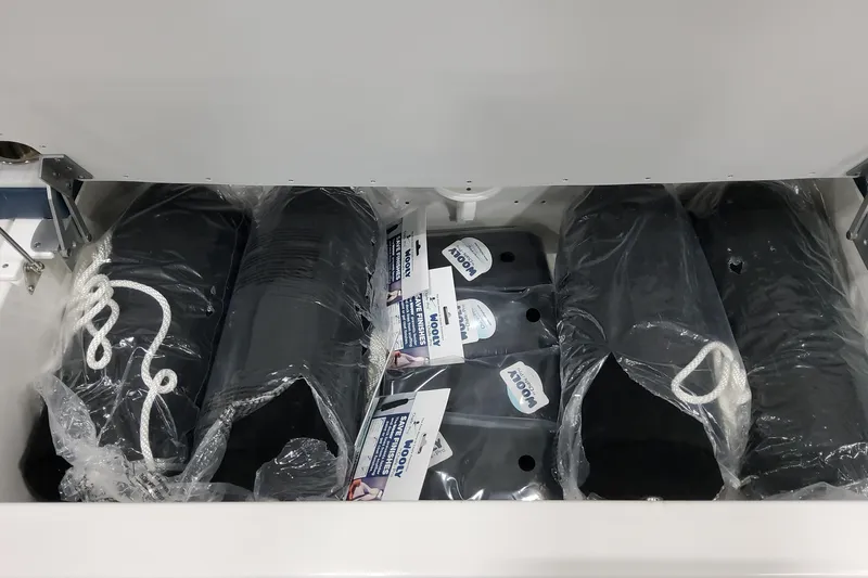 Slide: The Image of Storage compartment with packaged boat fenders and ropes in a 2026 Formula 380 Super Sport Crossover OB. - 47