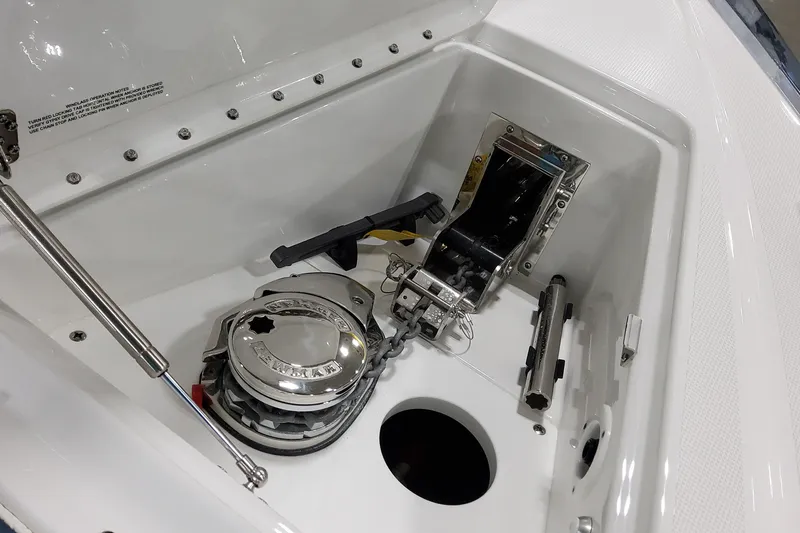 Slide: The Image of Anchor compartment of 2026 Formula 380 Super Sport Crossover OB boat, featuring winch and chain. - 54
