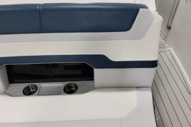 Slide: The Image of 2026 Formula 380 Super Sport Crossover OB interior seating with cup holders, blue and white upholstery. - 55