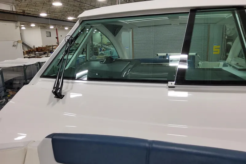 Slide: The Image of 2026 Formula 380 Super Sport Crossover OB boat windshield and wiper detail in a showroom. - 56