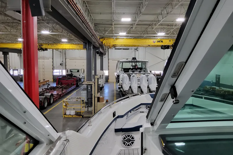 Slide: The Image of 2026 Formula 380 Super Sport Crossover OB in a factory setting with cranes and equipment. - 68