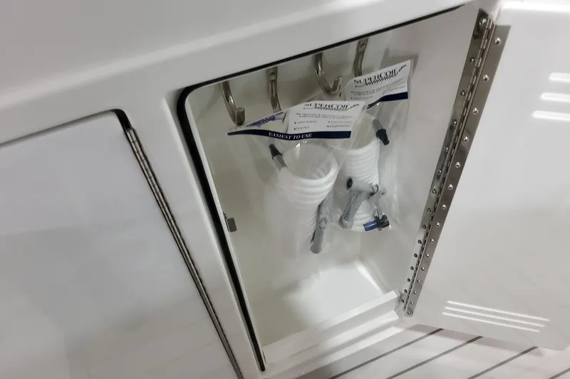 Slide: The Image of Storage compartment on 2026 Formula 380 Super Sport Crossover OB boat with coiled hoses. - 73