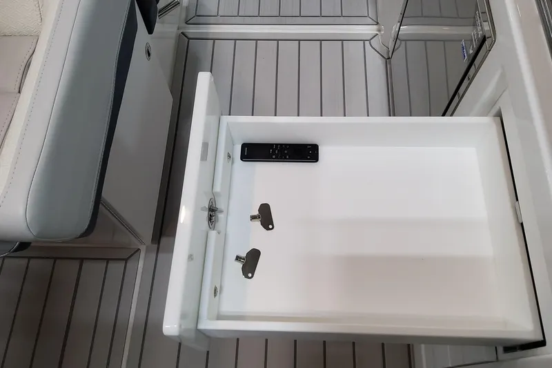 Slide: The Image of Open drawer in 2026 Formula 380 Super Sport Crossover OB with remote and keys. - 77