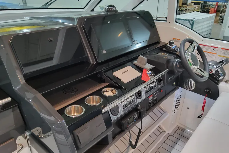 Slide: The Image of Helm of 2026 Formula 380 Super Sport Crossover OB with modern controls and displays. - 80