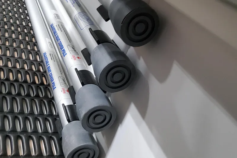 Slide: The Image of Adjustable boat cover poles on a textured surface, Formula 380 Super Sport Crossover OB, 2026. - 96