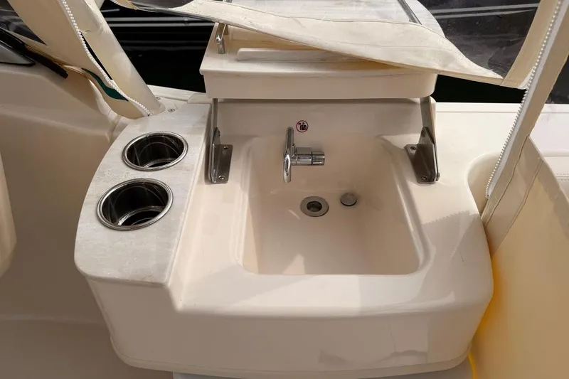 Slide: The Image of Grady-White Freedom 235 boat sink area with cup holders, 2025 model. - 10